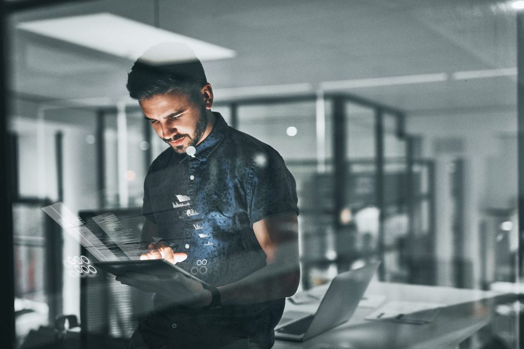 A man holding a tablet searching for IT Strategy Consulting service