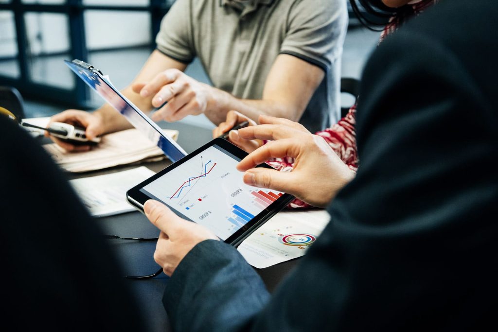 A picture showing people analysing statistics on the tablet